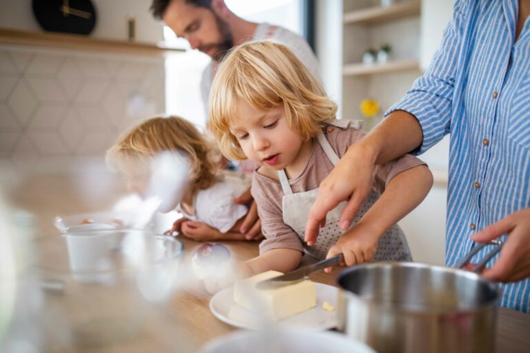 parents preparing food with young child