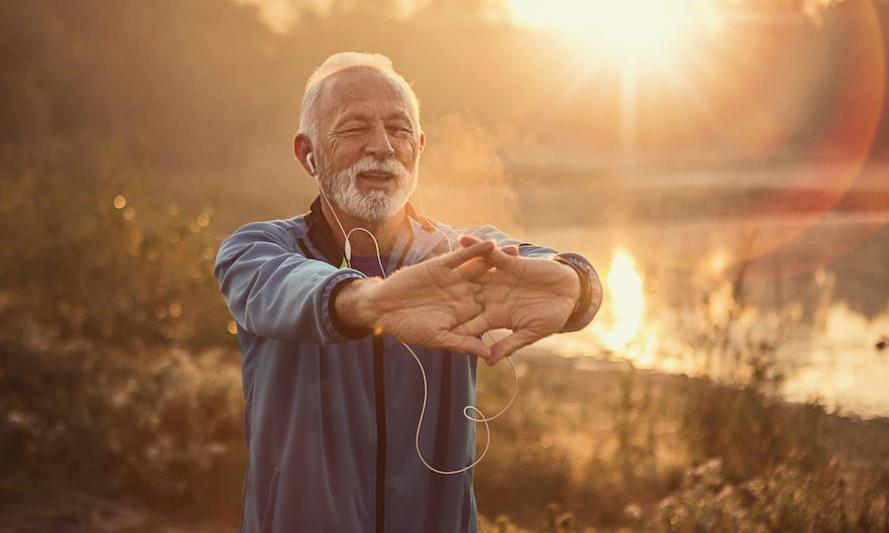 Healthy-Aging-Story-Photo man doing yoga outside