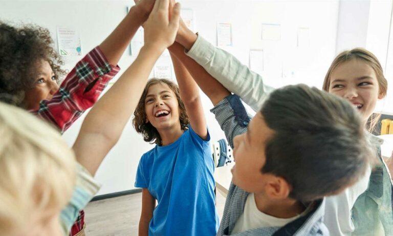 group of teens giving each other a high five