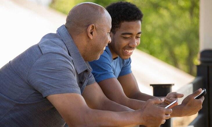 Father and son with cell phones