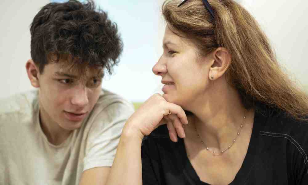 teen boy talking with mother