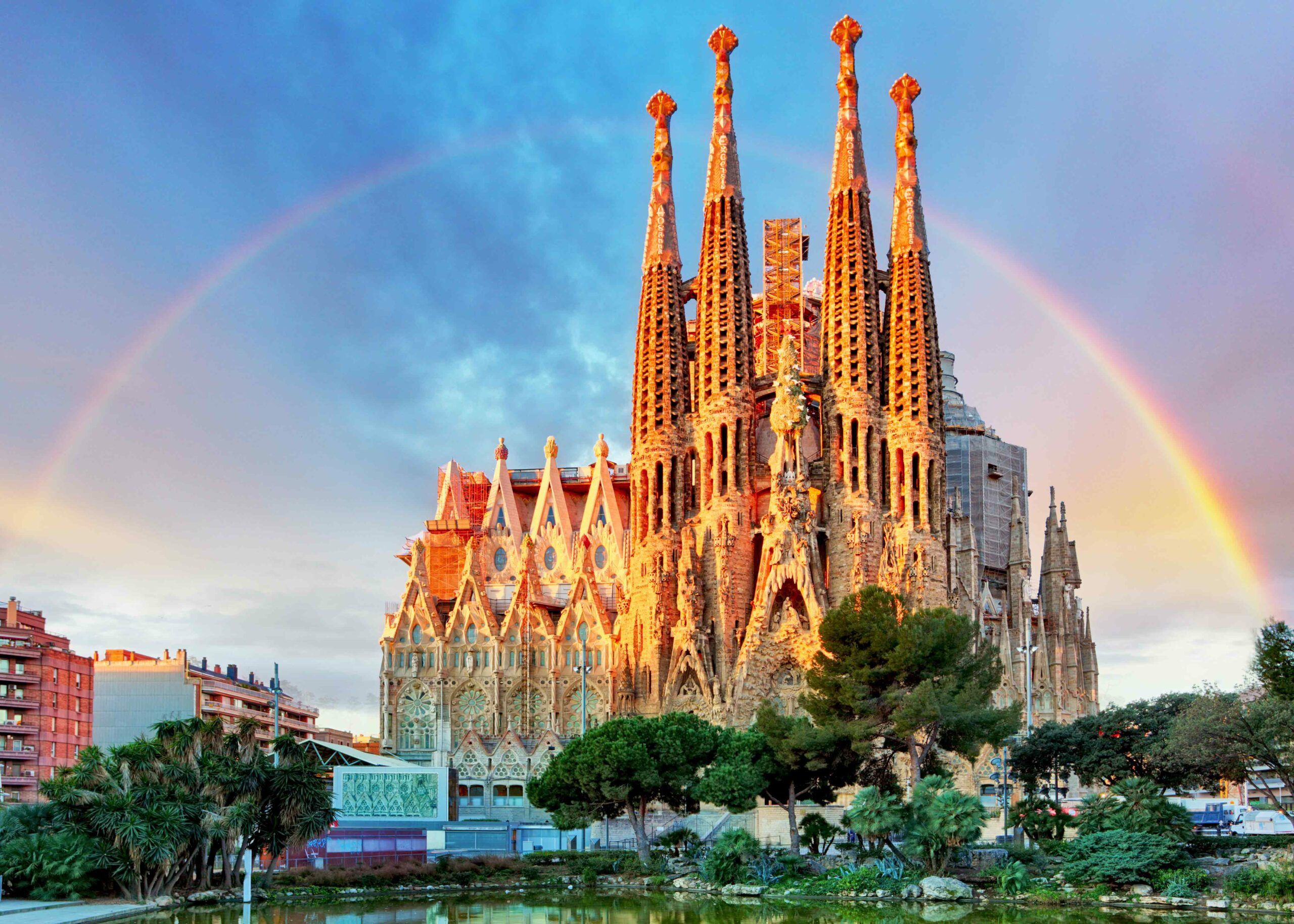 photo of the Sagrada Familia church with a rainbow over it