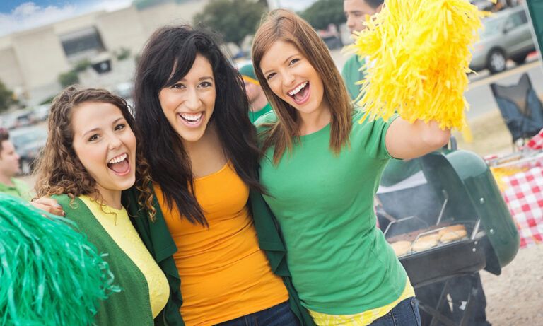 three female college students enjoying a tailgate party