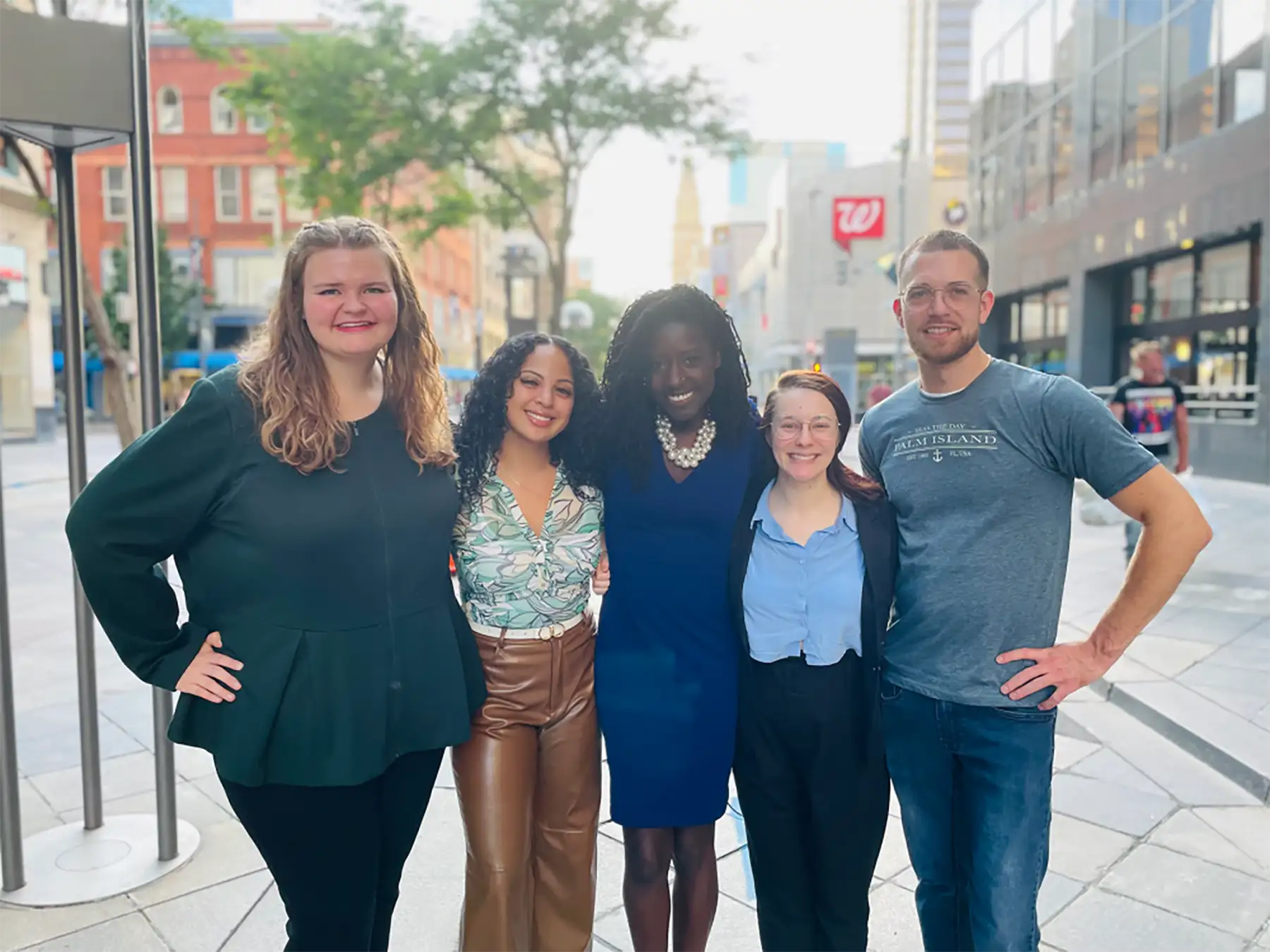 A group of people stand in the street in a city